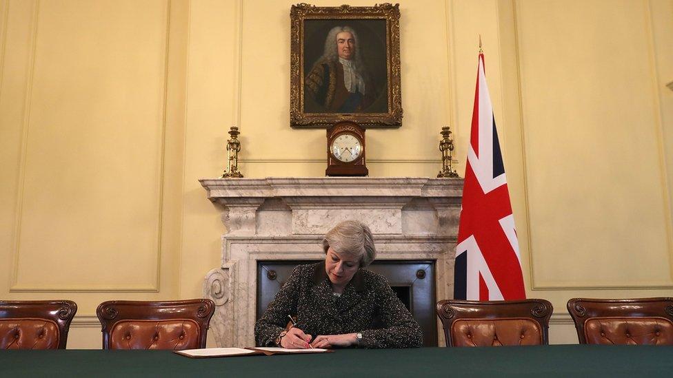 Theresa May signs the letter to the EU confirming the UK's departure