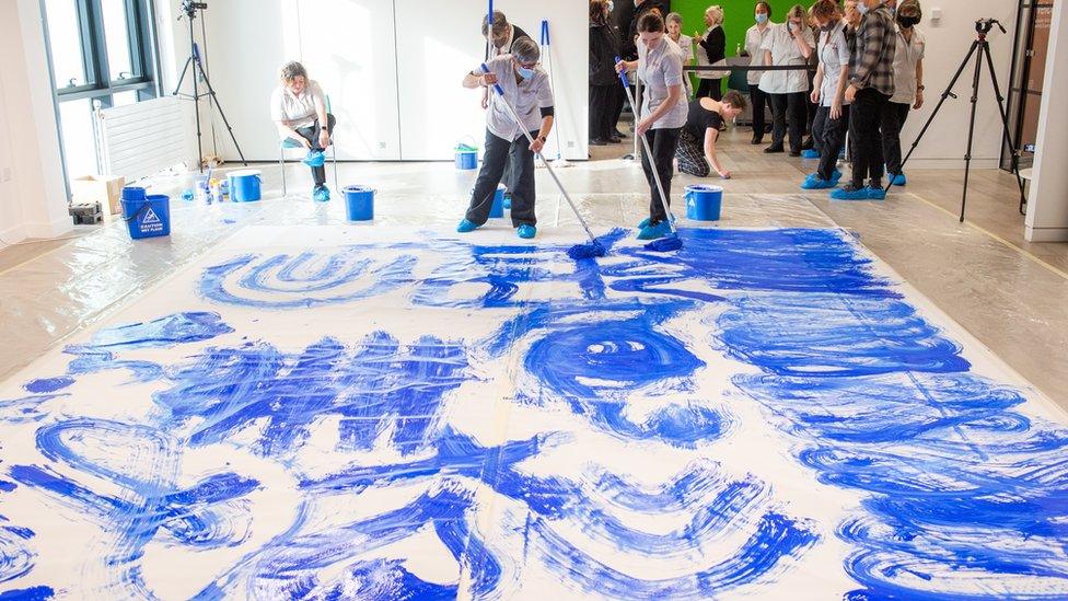 Cleaners creating artwork at Lancaster University