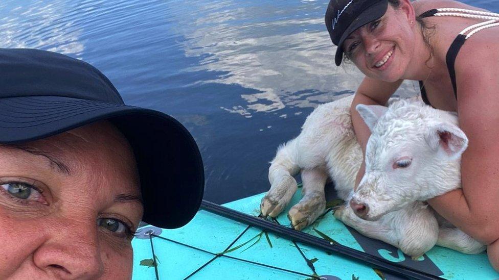 Michelle Brown (l) and Vicky Hamilton with the calf