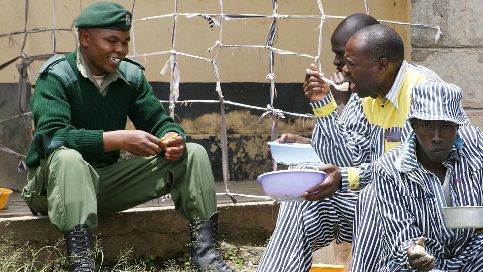 A guard chats to prisoners at Naivasha GK Prison