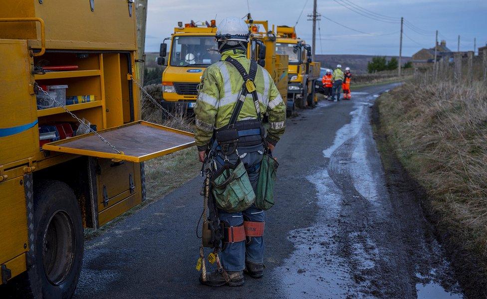 Northern Powergrid engineer wearing overalls and standing next to a truck