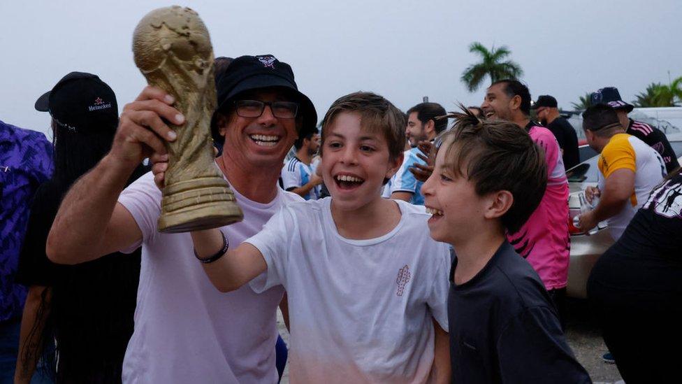 Inter Miami fans outside the stadium with a replica World Cup.