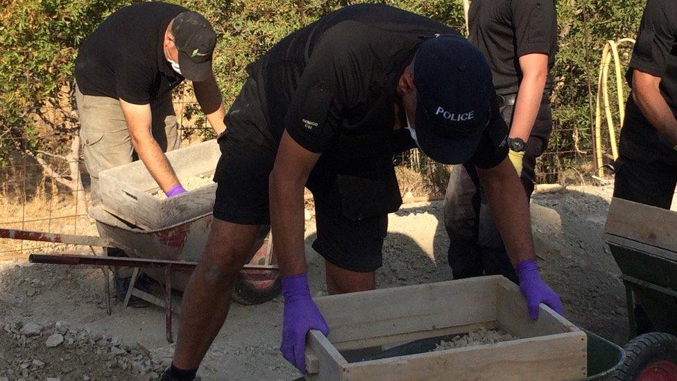 Men sieving soil