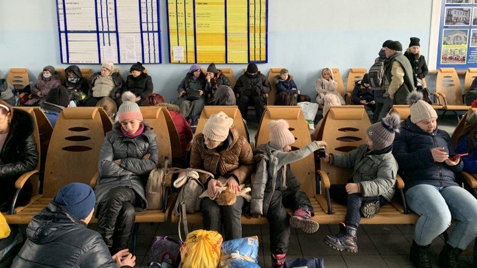 People waiting at Poltava station in Eastern Ukraine for trains west