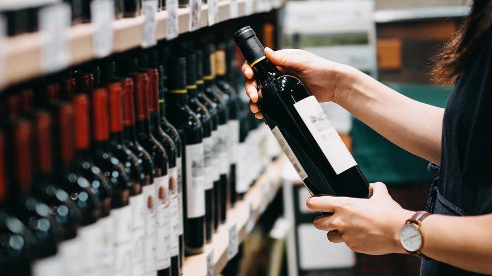 Woman choosing a bottle of wine