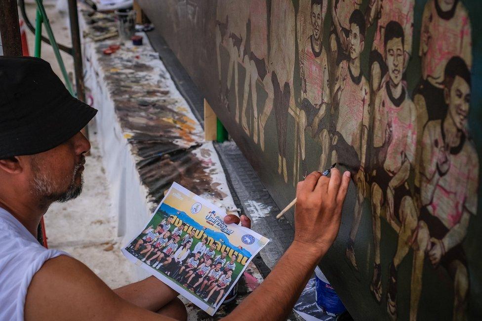 Artists work on an art mural at Art Bridge gallery in Chiang Rai, Thailand