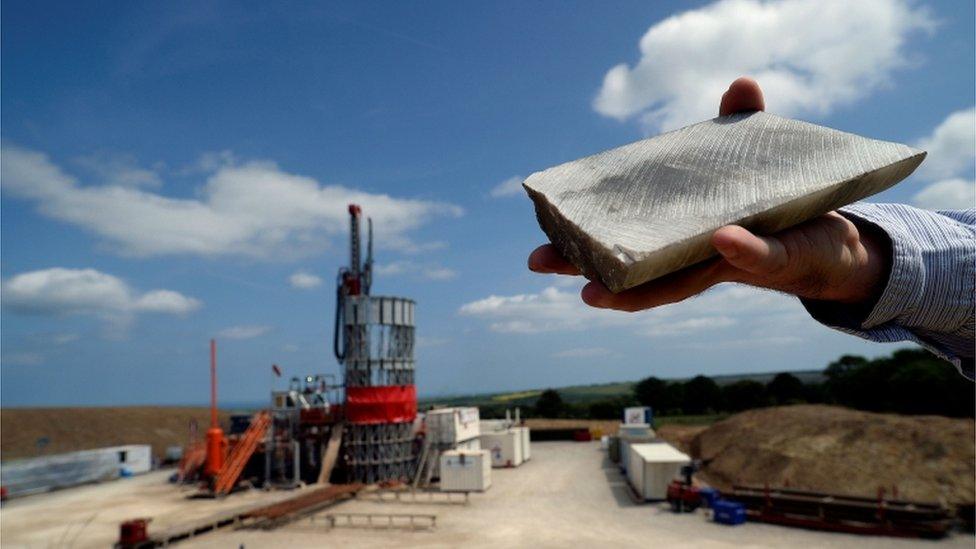 An employee holds a sample of polyhalite taken from the Sirius Minerals test drilling station on the North Yorkshire Moors near Whitby