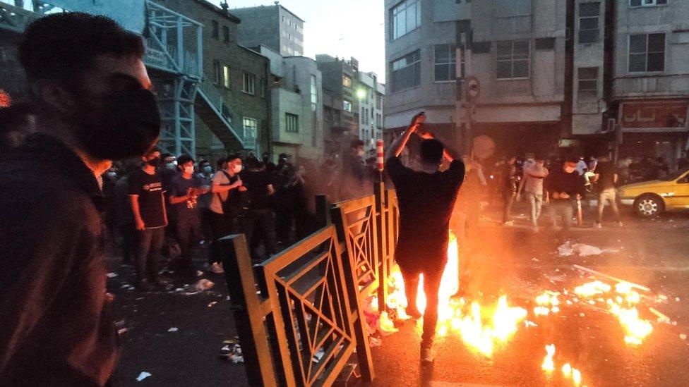 People clash with police during a protest following the death of Mahsa Amini, in Tehran, Iran (21 September 2022)