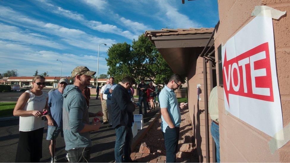 Voters wait in line in front of a polling station to cast their ballots in the US presidential election in Scottsdale, Arizona on 8 November 2016