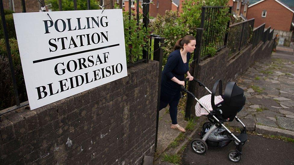 Polling station in Merthyr Tydfil with a woman exiting with a pushchair