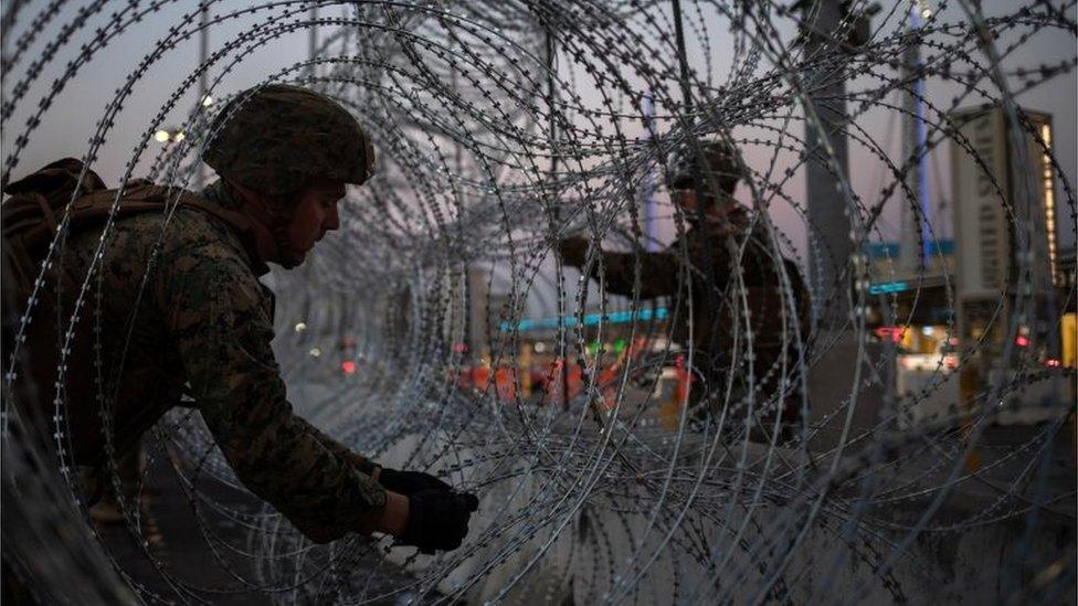 United States Marines fortify concertina wire along the San Ysidro Port of Entry border crossing as seen from Tijuana, Mexico November 20, 2018