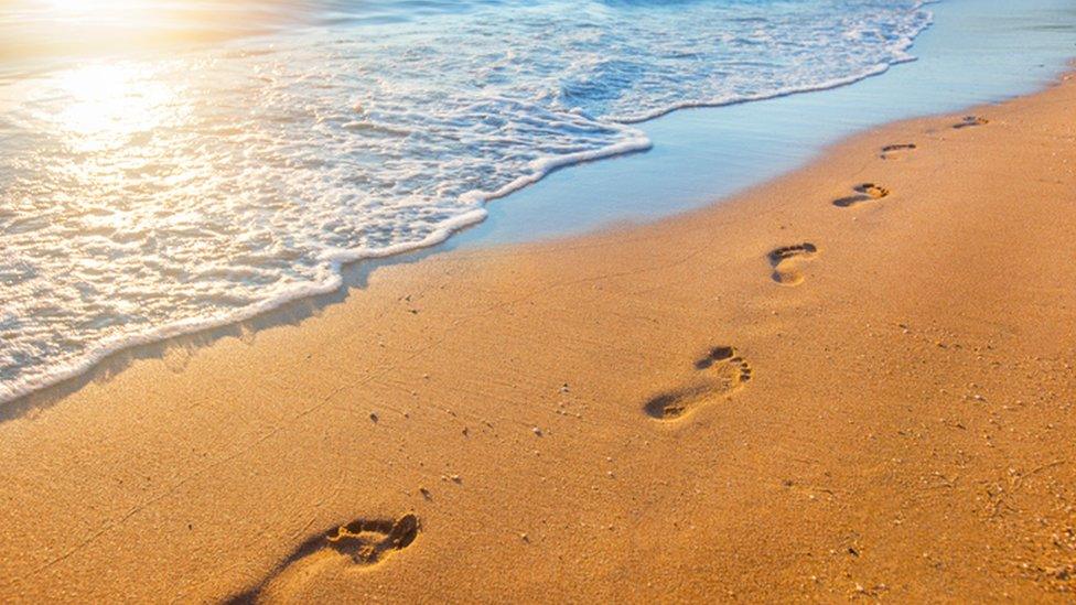 footprints in the sand, stock image