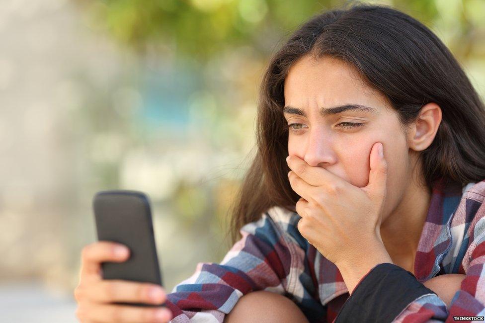 Teenager getting her results on her phone