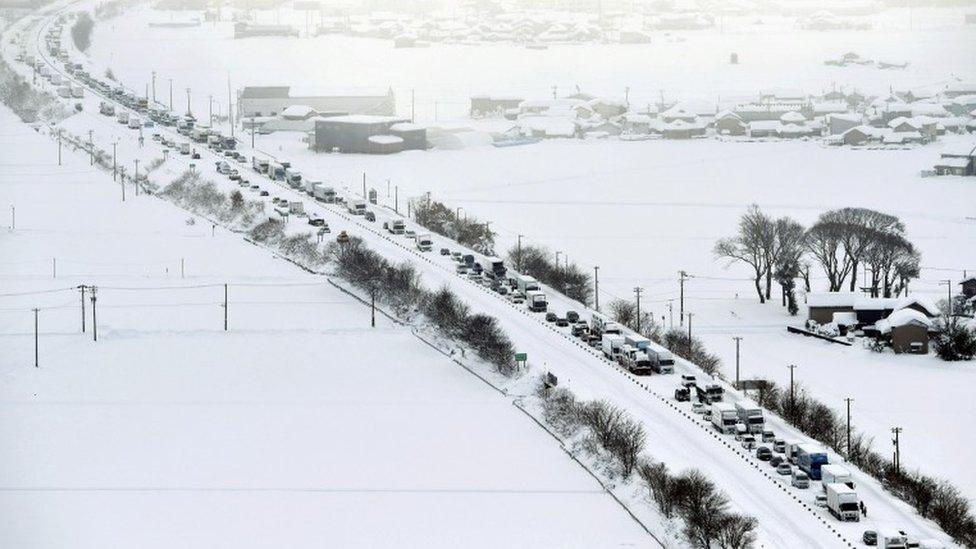 Vehicles are stranded in the snow on the Hokuriku Expressway in Fukui Prefecture, Japan.