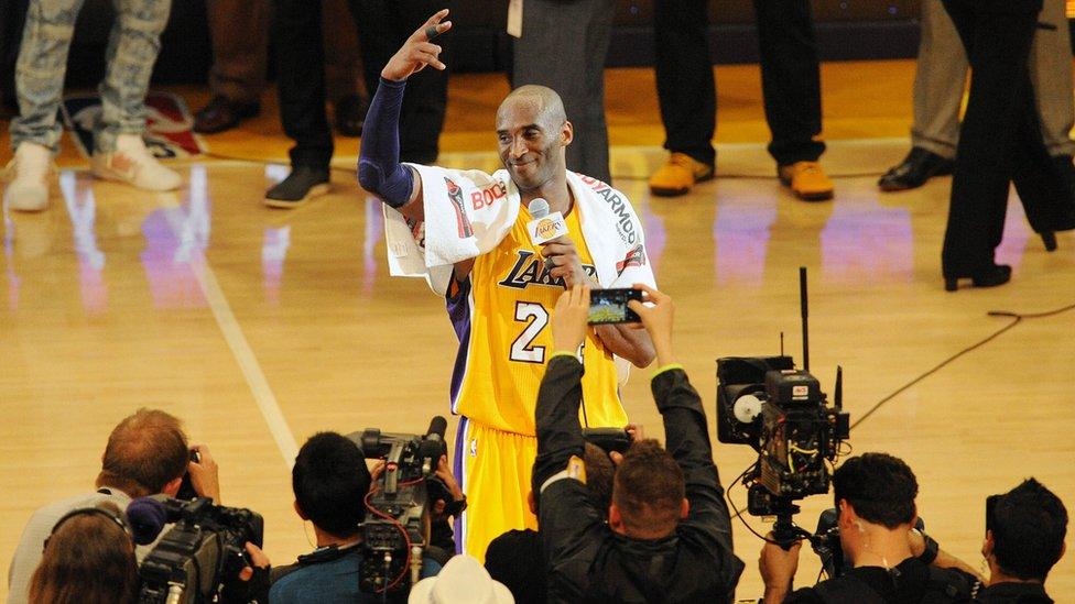 Los Angeles Lakers forward Kobe Bryant (24) speaks to the crowd following the 101-96 victory against Utah Jazz during the second half at Staples Center