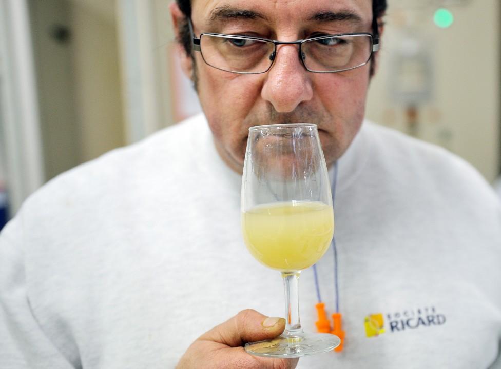 An employee of Pernod Ricard sniffing a glass