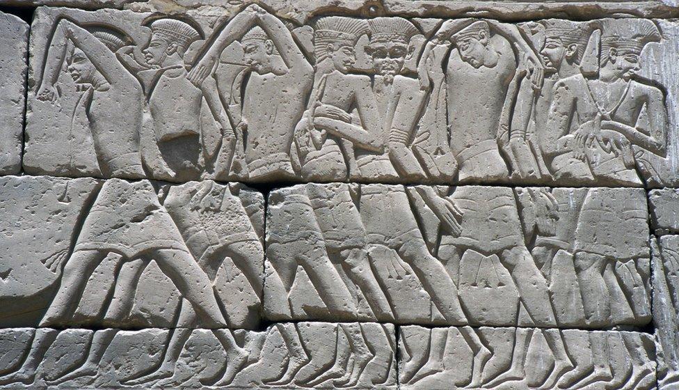 Sea Peoples: Shackled and bound Peleset or Philistine prisoners captured by Egyptians in a naval battle. On the walls of Ramses III's Medinet Habu temple