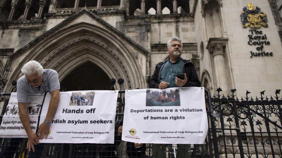 Asylum seeker rights campaigners outside the Royal Courts of Justice in London