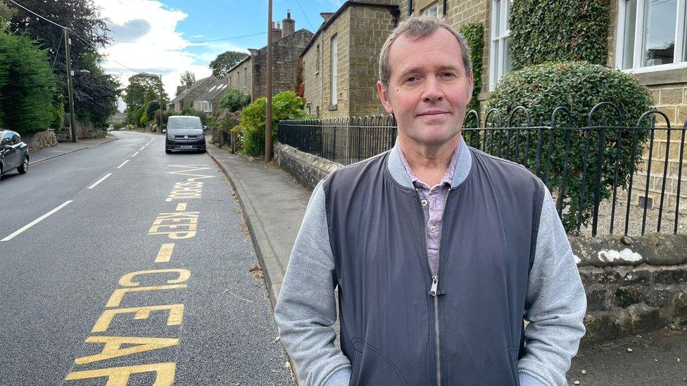 Greg Smith outside his home