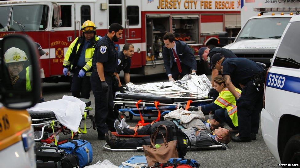 Paramedics treat passengers outside Hoboken station on 29 September 2016