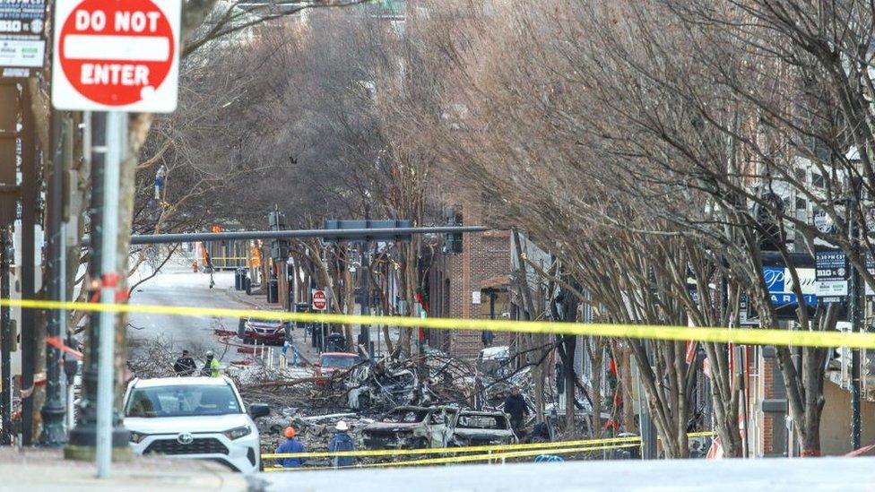 Police close off an area damaged by an explosion on Christmas morning