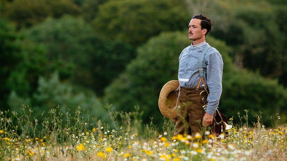 Man with a trumpet stood in a field for artwork called The Day Our World Changed by Wildworks