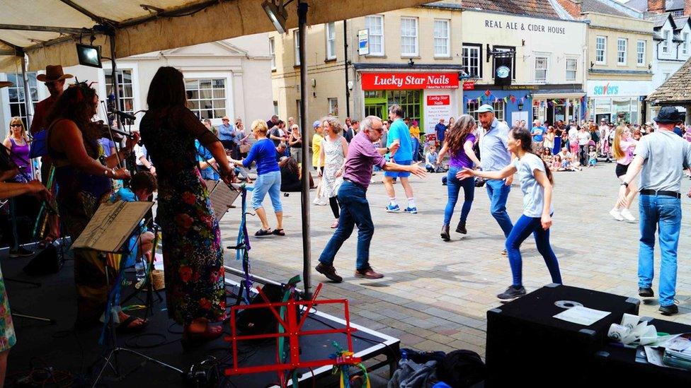 People dancing in front of a stage at Chippenham Folk Festival