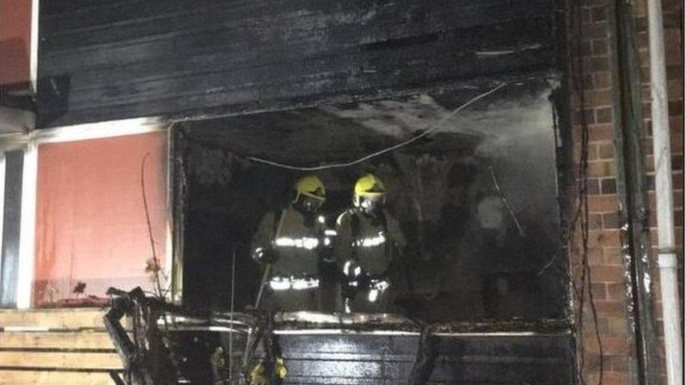 Firefighters in the fire-damaged house