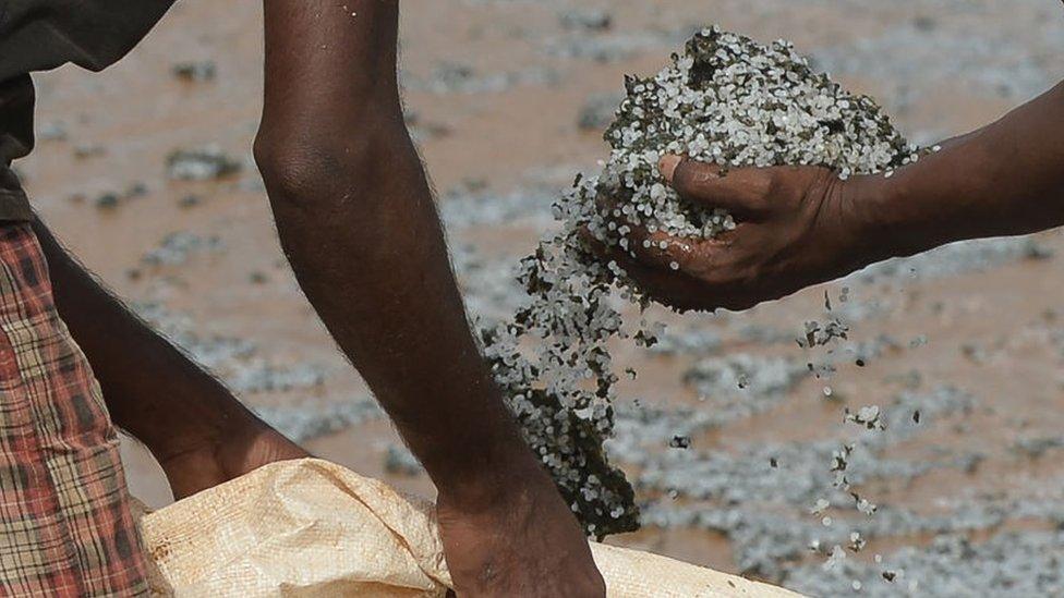 Residents collect debris washed ashore from the Singapore-registered container ship MV X-Press Pearl,