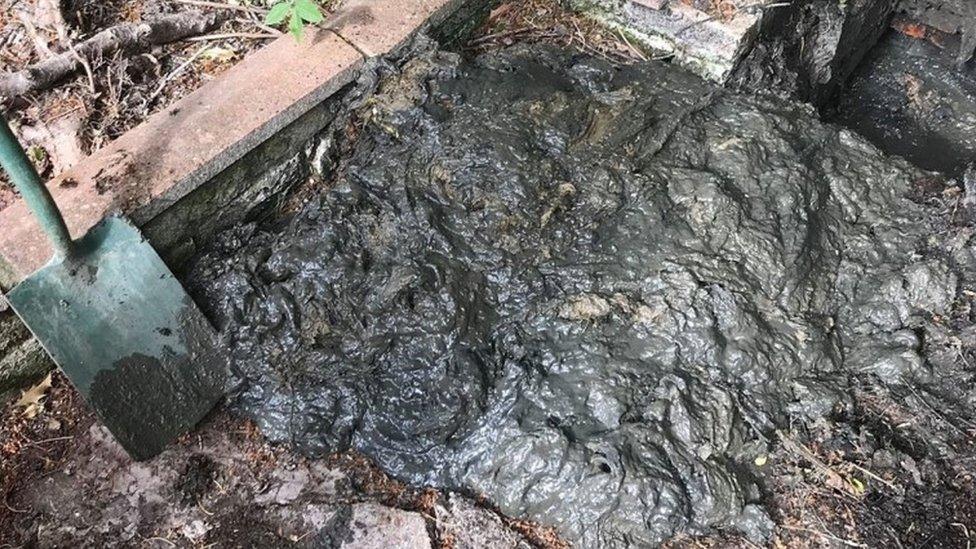 A mass of wet wipes being removed from a sewer