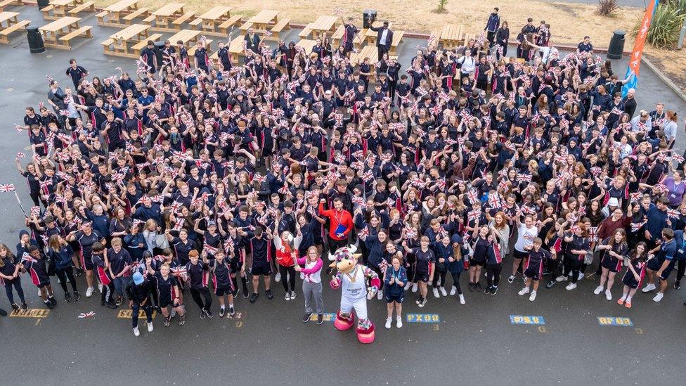 Crowd of children with mascot