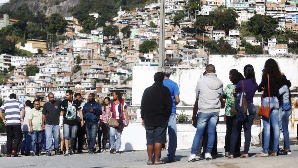 Mourners prepare to depart the cemetery after the burial of mother Marlene Maria Conceicao, 76, and daughter Ana Cristina Conceicao, 42, both residents of the Mangueira favela community, who were killed while caught in the crossfire of a shootout between police and gang members on July 3, 2017