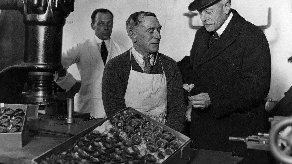 Earl Haig watches the stamping of poppies by ex-servicemen during a visit to the British Legion poppy factory at Richmond in 1926