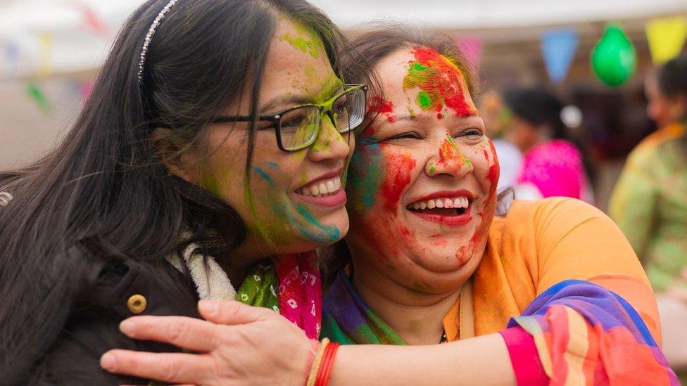 An image of two women at a Holi celebration