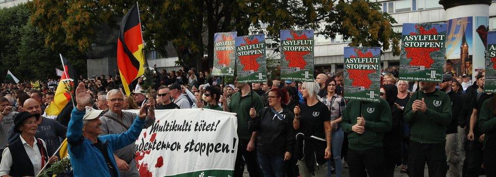 Protesters in Chemnitz on 27 August hold signs reading: 'Stop the Asylum Flood!'