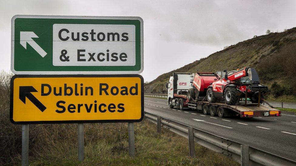 A lorry passing road signs near the Irish border