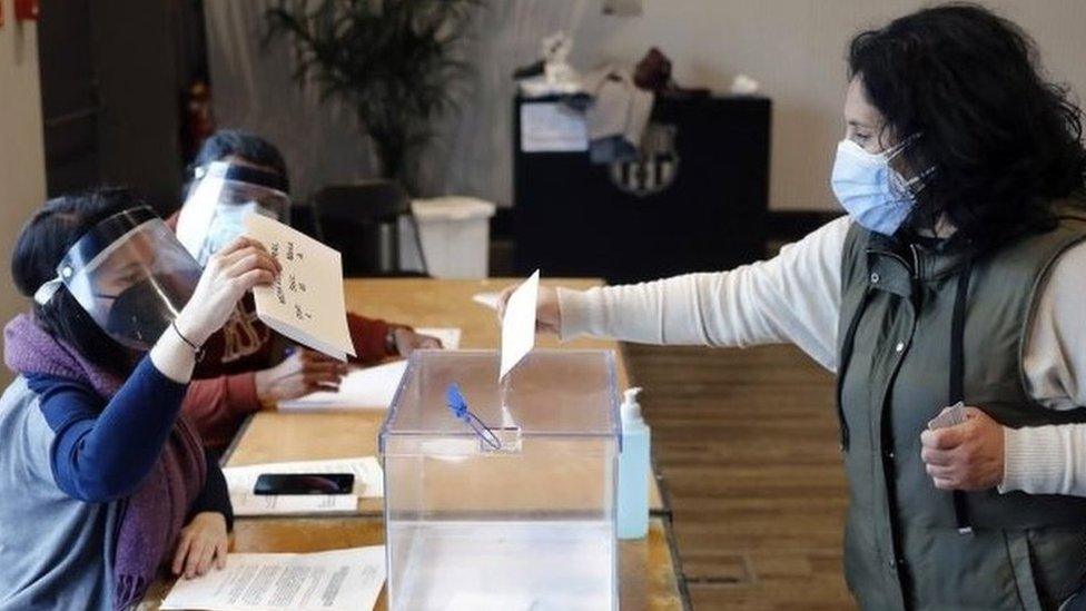 A woman casts her ballot at a polling station in Barcelona. Photo: 14 February 2021