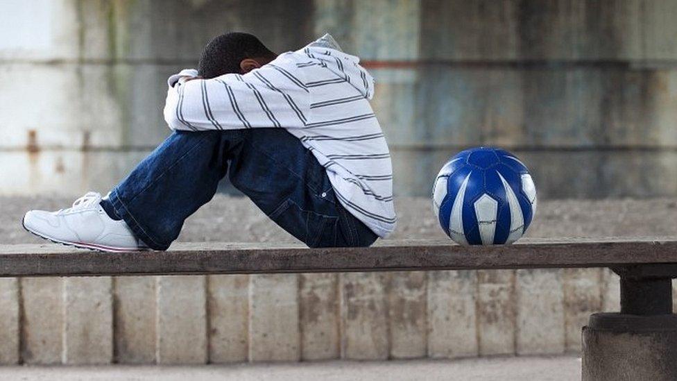 Boy sitting with ball