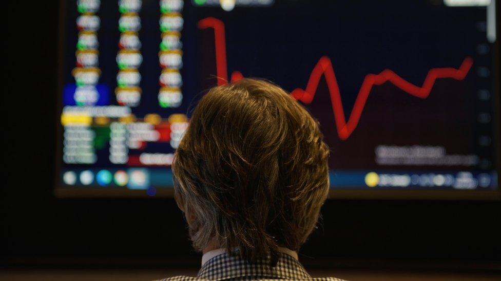 Man looking at chart on screen (stock picture)