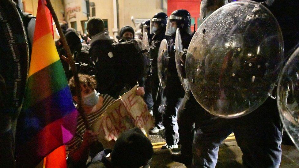 Protester against police riot shields