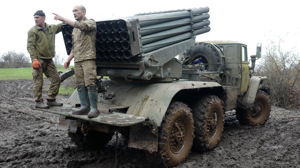 The artilleryman nicknamed Lysyi (right) supervises the reloading of a BM-21 Grad missile launcher