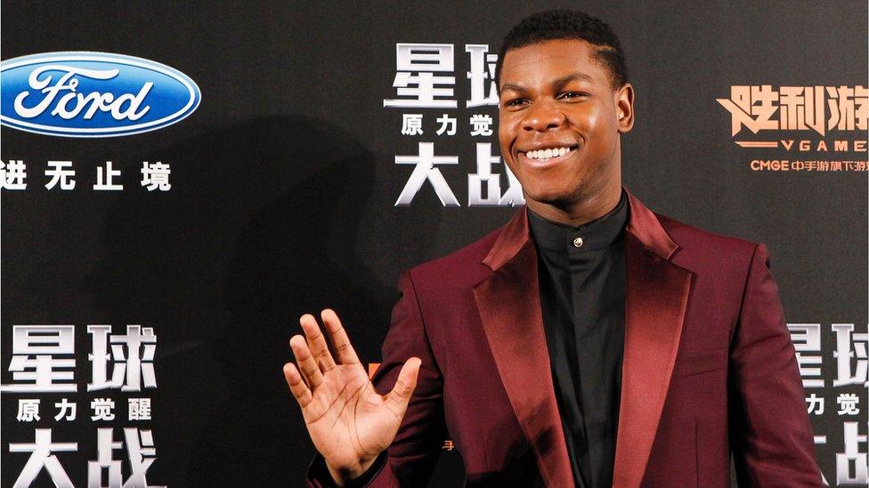 British actor John Boyega waves to fans during the Shanghai premiere of "Star Wars: The Force Awakens"