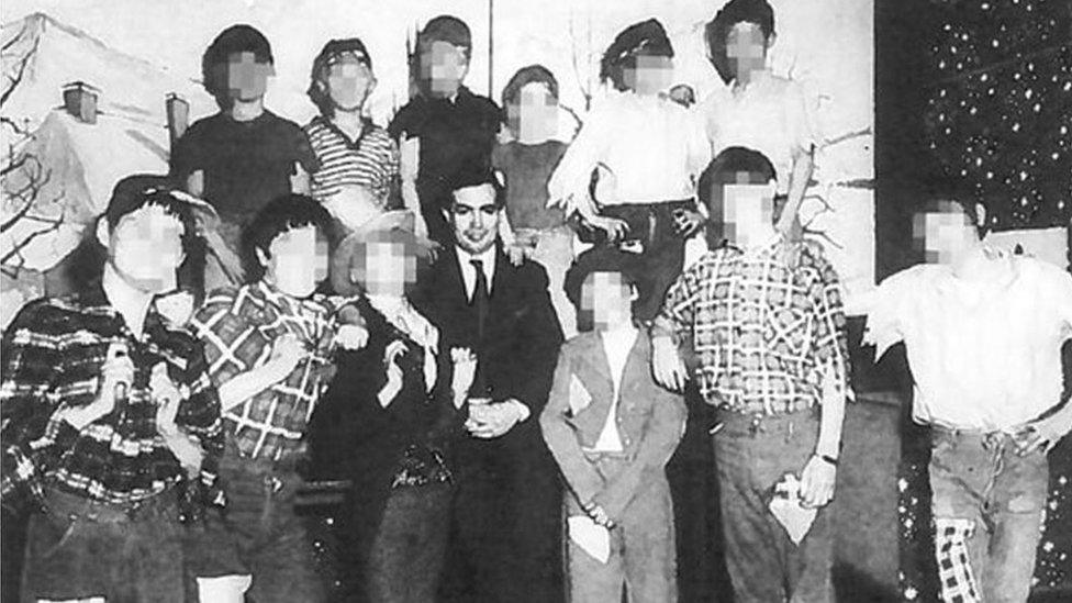 John Allen in an old photo surrounded by unidentifiable children