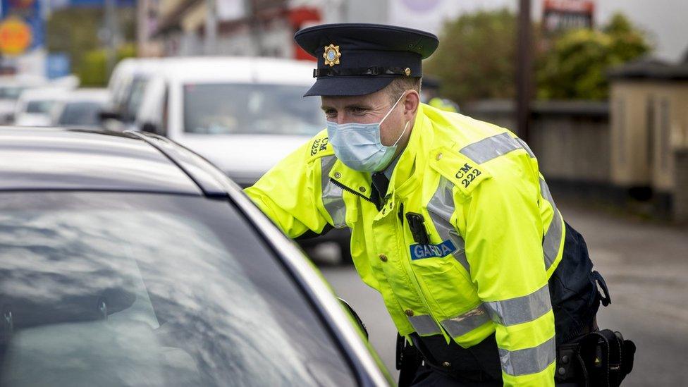 A garda (Irish police officer) performing a random vehicle check on the Donegal/Londonderry border.