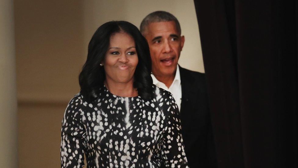 Former President Barack Obama and his wife Michelle arrive for a roundtable discussion at the South Shore Cultural Center in Chicago, Illinois.