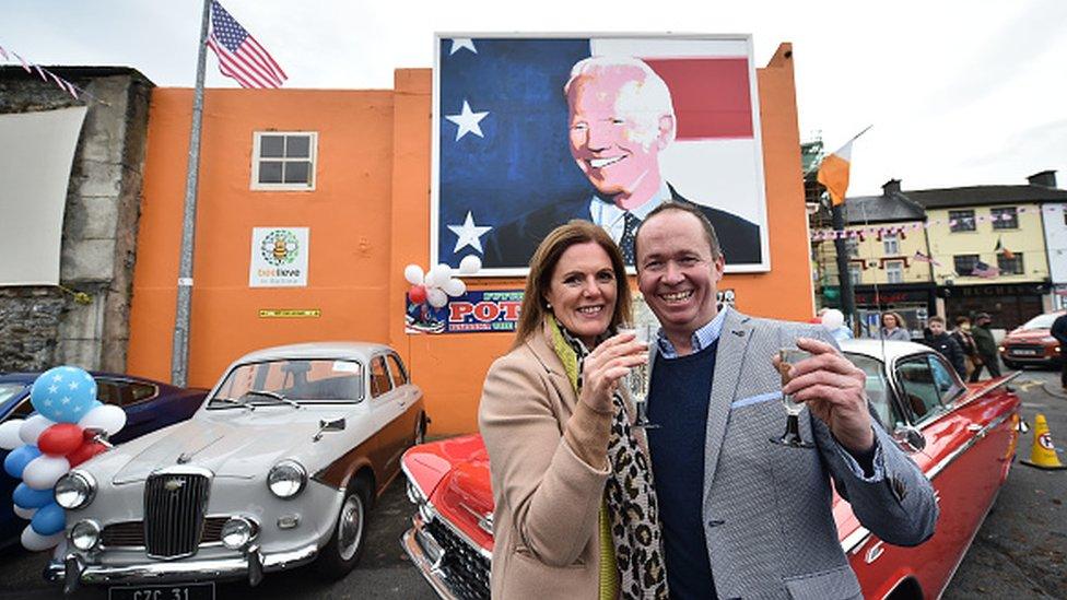 Joe Blewitt and his wife Deirdre drink champagne underneath a mural of their third cousin Joe Biden