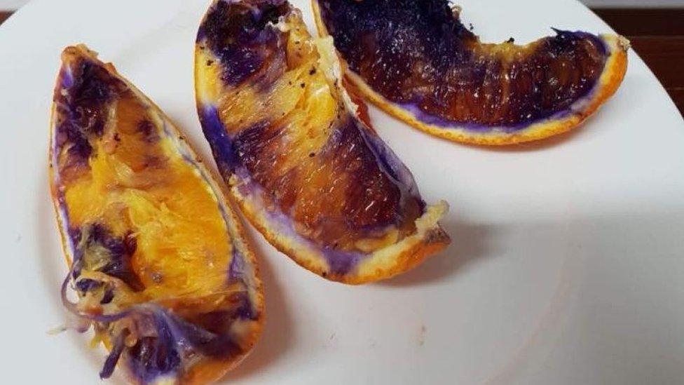 Three orange slices that turned purple