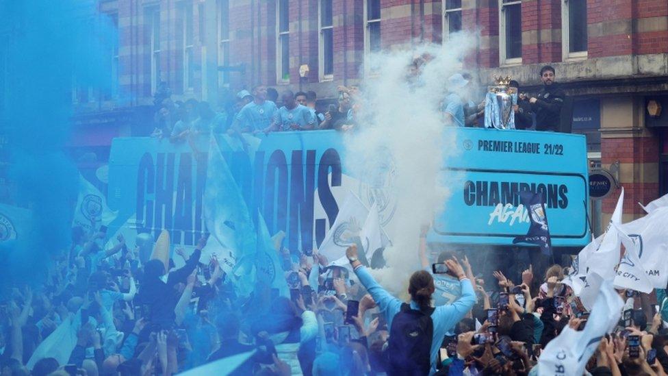 Manchester City players celebrate with the Premier League trophy during the victory parade