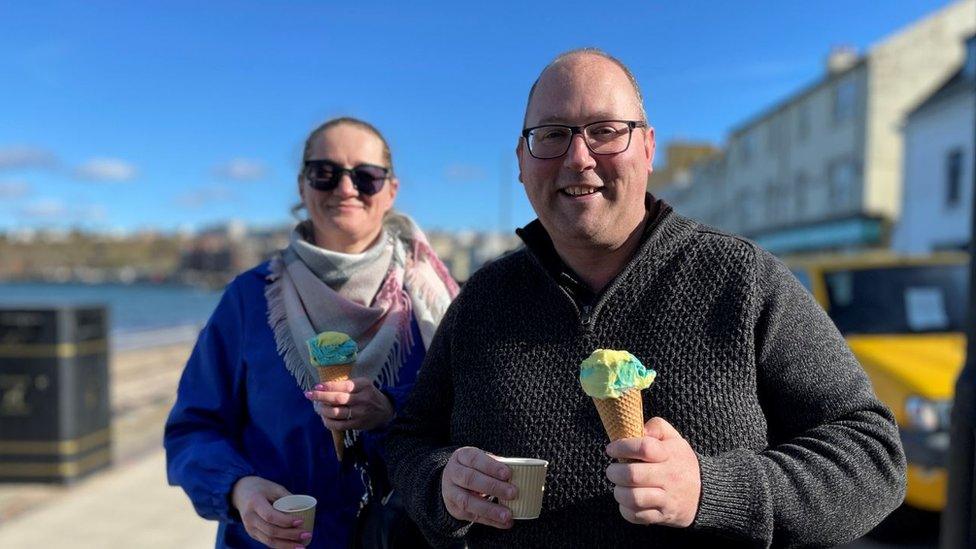 Richard Karran and partner in Peel holding blue and yellow ice creams