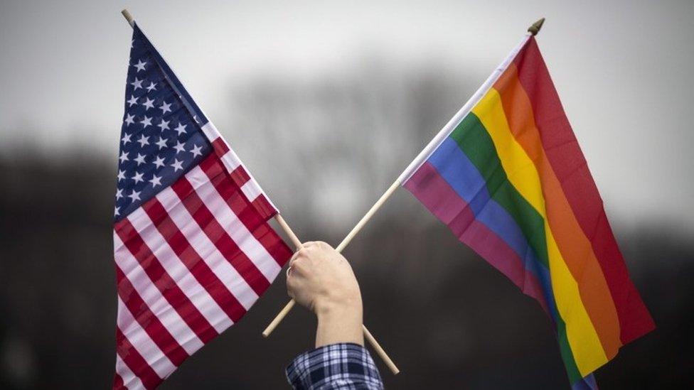 Protester with US and LGBT flag